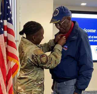 Veteran getting pin from his granddaughter