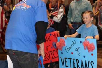 Little boy with welcome home sign at the airport