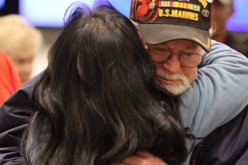 Woman hugging veteran