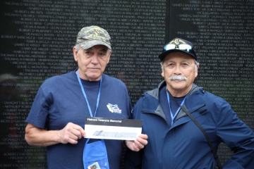 Veterans with rubbing from Vietnam Wall